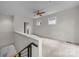 Open loft space with carpeted floors, ceiling fan, and natural light from the windows at 625 N Alexander St, Charlotte, NC 28202