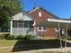Home exterior highlighting a screened-in porch and covered carport for convenient parking at 6585 White St, Kershaw, SC 29067