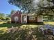 Charming brick home with a covered porch, blue shutters, and beautiful landscaping at 6585 White St, Kershaw, SC 29067