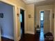 Hallway with wood floors, neutral walls, and multiple doorways at 6585 White St, Kershaw, SC 29067