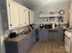 Well-lit kitchen with wooden floors, stainless steel sink, and plenty of counter space at 6585 White St, Kershaw, SC 29067