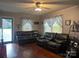 Living room featuring hardwood floors, a ceiling fan, and leather couches at 6585 White St, Kershaw, SC 29067