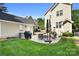Backyard patio with an outdoor kitchen and lush lawn at 7814 Knox Ridge Rd, Huntersville, NC 28078