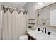 Bright bathroom featuring decorative shower curtain, shelving and framed mirror at 7814 Knox Ridge Rd, Huntersville, NC 28078
