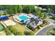 Aerial view of community pool with clubhouse, surrounded by lush landscaping and mature trees, neighborhood amenity at 7814 Knox Ridge Rd, Huntersville, NC 28078