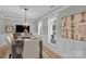 Dining room with a wooden table and seating for six, accentuated by crown molding and shutters at 7814 Knox Ridge Rd, Huntersville, NC 28078