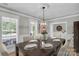 Formal dining area features a dark wood table, seating for six, and decorative lighting at 7814 Knox Ridge Rd, Huntersville, NC 28078
