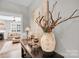 Elegant entryway table with decorative vase and candles leading to a living room at 7814 Knox Ridge Rd, Huntersville, NC 28078