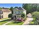 Charming two-story home with a welcoming front porch, flower garden and a detached garage at 7814 Knox Ridge Rd, Huntersville, NC 28078
