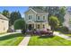 Charming two-story home with a welcoming front porch and beautifully landscaped front yard, offering curb appeal at 7814 Knox Ridge Rd, Huntersville, NC 28078