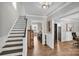 Welcoming foyer with staircase, hardwood floors, and decorative accents, creating an inviting atmosphere at 7814 Knox Ridge Rd, Huntersville, NC 28078
