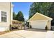 View of fenced in back yard, deck and detached garage with white door at 7814 Knox Ridge Rd, Huntersville, NC 28078