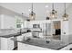 Bright kitchen with stainless appliances, granite counters, island with overhang, and decorative pendant lighting at 7814 Knox Ridge Rd, Huntersville, NC 28078