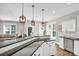 Open kitchen with granite counters, eat-in island, stainless appliances, and seamless flow to the living room at 7814 Knox Ridge Rd, Huntersville, NC 28078