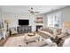 Cozy living room featuring a fireplace, plush sofa, entertainment center, and hardwood floors at 7814 Knox Ridge Rd, Huntersville, NC 28078