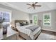 A spacious main bedroom with tray ceiling, ceiling fan and large window with wood shutters at 7814 Knox Ridge Rd, Huntersville, NC 28078