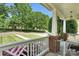Charming covered porch with lush lawn and landscape views at 7814 Knox Ridge Rd, Huntersville, NC 28078
