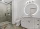 Stylish bathroom featuring a glass shower, sleek fixtures, and modern lighting at 8044 Edgewater Dr # 100, Norwood, NC 28128