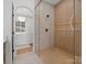 Stylish glass shower with wood paneling, tile walls, and luxury fixtures at 8044 Edgewater Dr # 100, Norwood, NC 28128