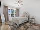 Bright bedroom featuring a ceiling fan, large window with lake views, and stylish decor at 8044 Edgewater Dr # 100, Norwood, NC 28128