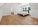Bright bedroom with hardwood floors, ceiling fan, and natural light from three windows at 8044 Edgewater Dr # 100, Norwood, NC 28128
