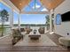 Relax on this covered deck overlooking the lake with comfortable seating and a wood ceiling at 8044 Edgewater Dr # 100, Norwood, NC 28128
