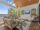 Enjoy the outdoors on this covered deck featuring a lake view, comfortable seating, and a TV at 8044 Edgewater Dr # 100, Norwood, NC 28128