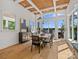 Bright dining room features a modern chandelier, large windows, and hardwood floors at 8044 Edgewater Dr # 100, Norwood, NC 28128