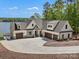 Stunning new construction home boasting a circular driveway and three-car garage at 8044 Edgewater Dr # 100, Norwood, NC 28128