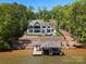 Beautiful lakefront home with a pool, private dock, and lush green landscaping at 8044 Edgewater Dr # 100, Norwood, NC 28128