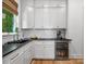 Bright kitchenette featuring white cabinets, black countertops, and a beverage refrigerator at 8044 Edgewater Dr # 100, Norwood, NC 28128