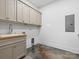 Clean laundry room with a sink, gray cabinets, and ample storage space at 8044 Edgewater Dr # 100, Norwood, NC 28128
