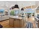 Open-concept living and dining area features large windows and an island kitchen at 8044 Edgewater Dr # 100, Norwood, NC 28128