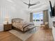 This main bedroom features an accent wall, a lake view, and a ceiling fan at 8044 Edgewater Dr # 100, Norwood, NC 28128