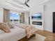 Bright main bedroom with water view, tray ceiling, fireplace, and ceiling fan at 8044 Edgewater Dr # 100, Norwood, NC 28128