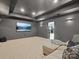 Media room with gray walls and lake view through adjacent room's windows at 8044 Edgewater Dr # 100, Norwood, NC 28128