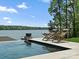 Relaxing pool area featuring lounge chairs and tranquil lake views at 8044 Edgewater Dr # 100, Norwood, NC 28128