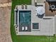 An aerial view of a luxurious pool with a sun deck, manicured lawn, and elegant landscaping create an outdoor oasis at 8044 Edgewater Dr # 100, Norwood, NC 28128