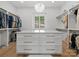 Well-organized walk-in closet with custom shelving, drawers, and decorative chandelier at 8044 Edgewater Dr # 100, Norwood, NC 28128