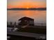Sunset view overlooking the lake and private dock, creating a serene and picturesque waterfront setting at 8044 Edgewater Dr # 100, Norwood, NC 28128