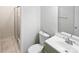 Bathroom featuring a walk-in shower, white toilet and sink with updated fixtures at 8600 Eaglewind Dr, Charlotte, NC 28212