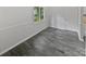 Bright bedroom features neutral walls, stylish gray tile floor, and natural light from windows at 8600 Eaglewind Dr, Charlotte, NC 28212
