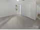 This bedroom features neutral walls, carpet floor, and natural light from windows at 8600 Eaglewind Dr, Charlotte, NC 28212