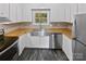 This kitchen features butcher block counters, stainless steel appliances, white cabinets, and stainless steel sink at 8600 Eaglewind Dr, Charlotte, NC 28212
