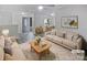 Bright living room with modern furnishings, stylish decor, and a seamless flow to the dining area at 8600 Eaglewind Dr, Charlotte, NC 28212