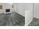 Modern living room featuring sleek flooring, a cozy fireplace, and ample natural light for a warm ambiance at 8600 Eaglewind Dr, Charlotte, NC 28212