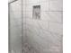 Walk-in shower features white tile walls, decorative inlay and glass door at 8600 Eaglewind Dr, Charlotte, NC 28212