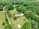 A bird's-eye view featuring home's setting on a large lot with mature trees and the adjacent road at 895 Furnace Rd, Iron Station, NC 28080