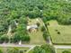 Expansive aerial view of a private estate, with trees, lawns, and outbuildings at 895 Furnace Rd, Iron Station, NC 28080