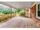 Spacious back porch with wood decking, offering a view of lush greenery at 895 Furnace Rd, Iron Station, NC 28080